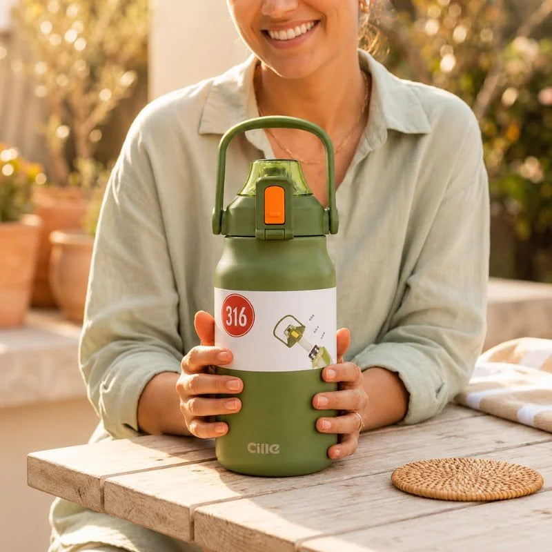 green insulated water bottle with carry handle during outdoor use